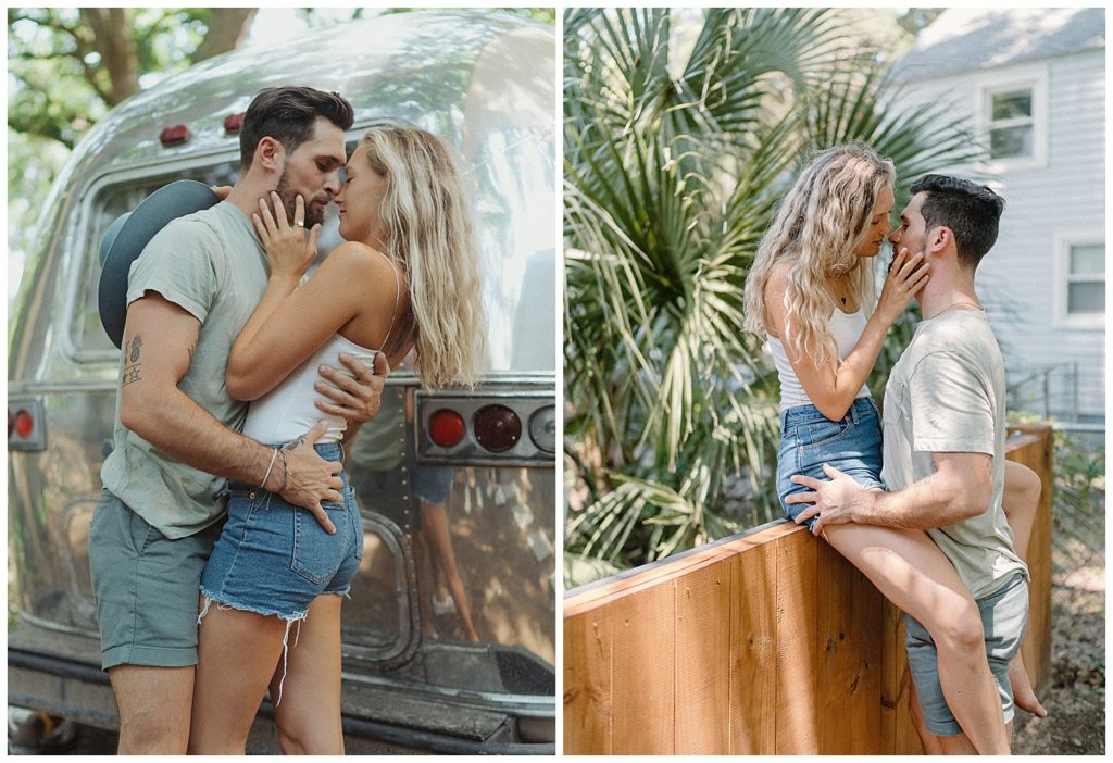 a couple sitting on the fence by an airstream about to kiss with palm trees behind them in florida