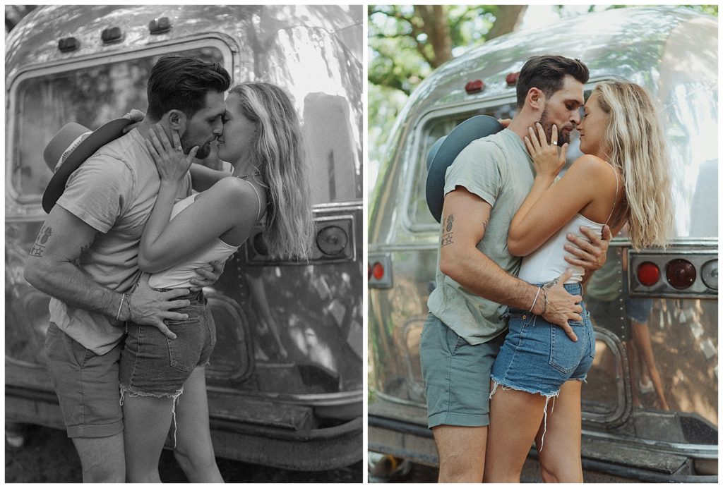 a couple hugging and kissing in front of an airstream in florida
