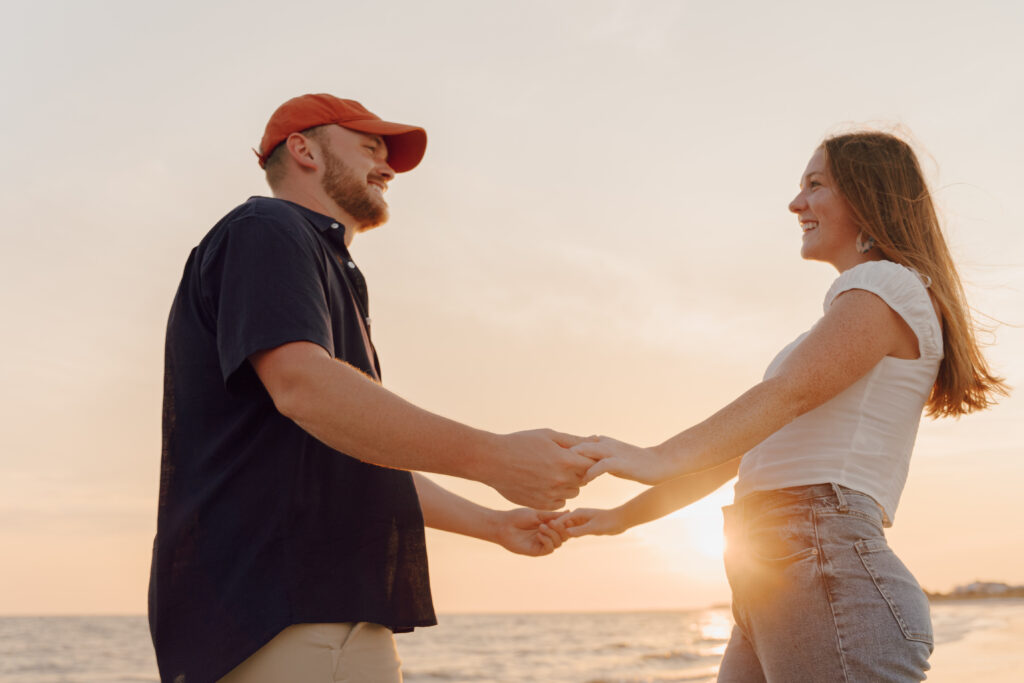 Couple holding hands during couples session at Alligator Point in Florida