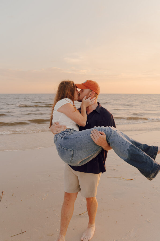 Couple kissing by the ocean during couples session