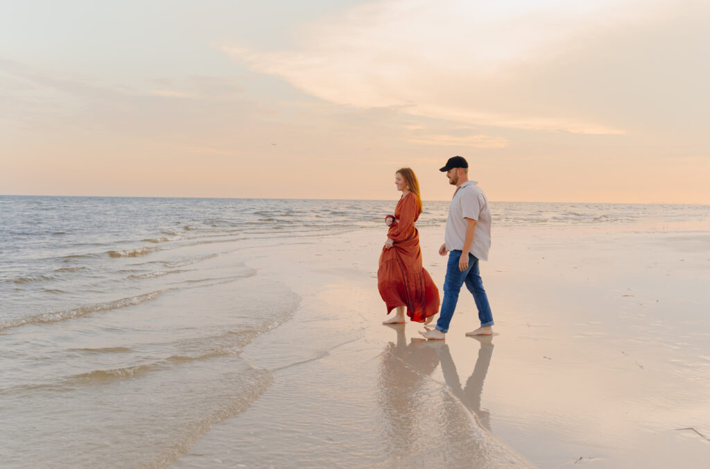 Couple walking by the ocean during couples session