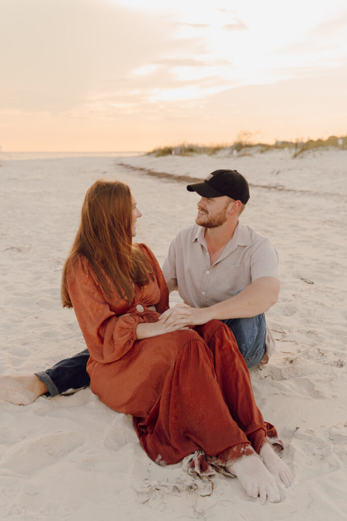 Couple sat in the sand during beach photoshoot at Alligator Point in Florida