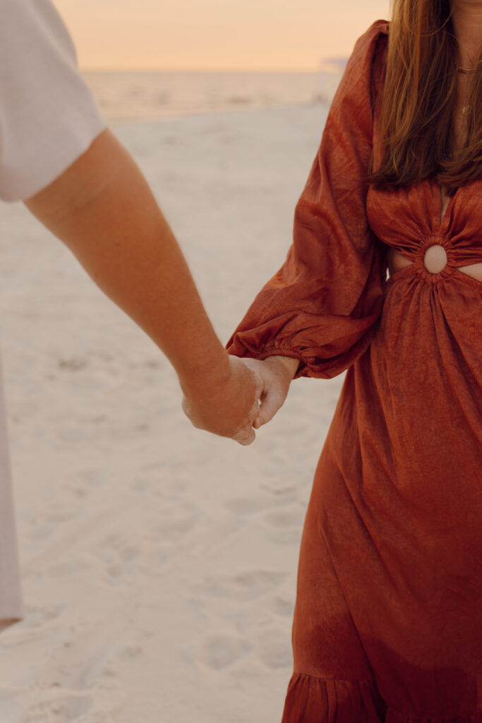 Couple walking and holding hands during couples session