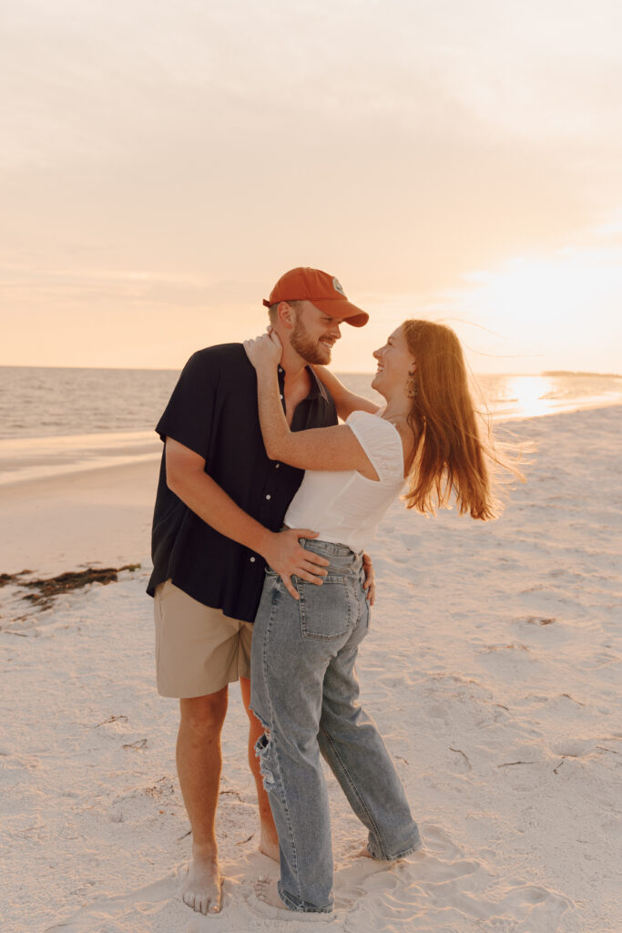 Couple kissing during beach couples session at Alligator Point in Florida