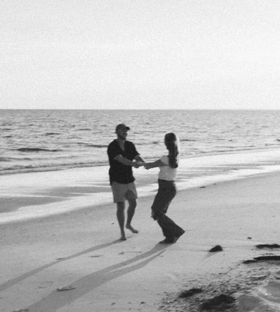 Couple dancing by the ocean during couples session