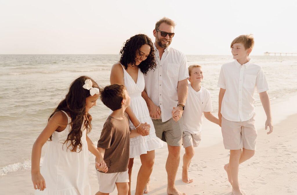 Family walking along the beach at family photo session at Destin Beach in Florida