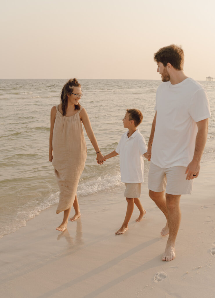 Family walking along the beach at family photo session