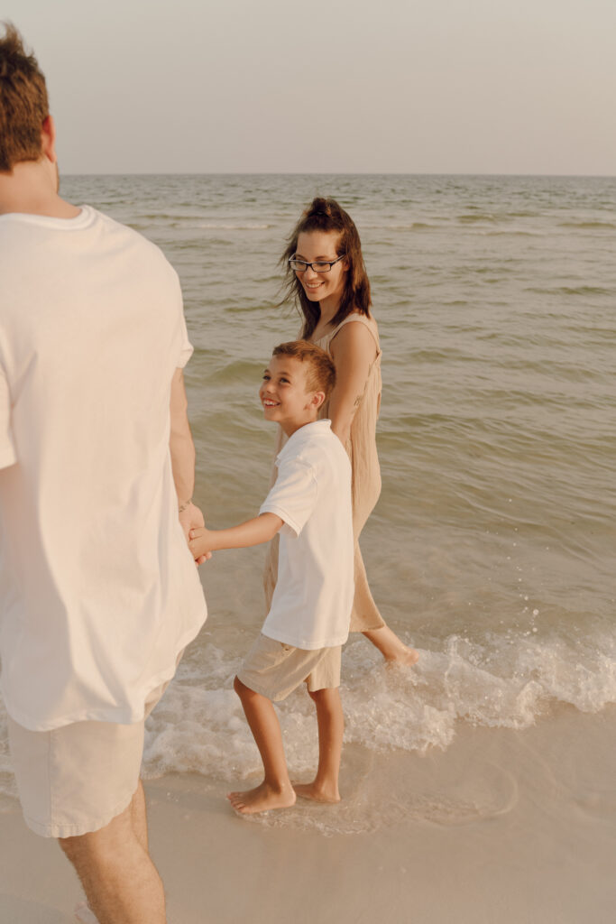 Family walking by the sea at Destin Beach in Florida