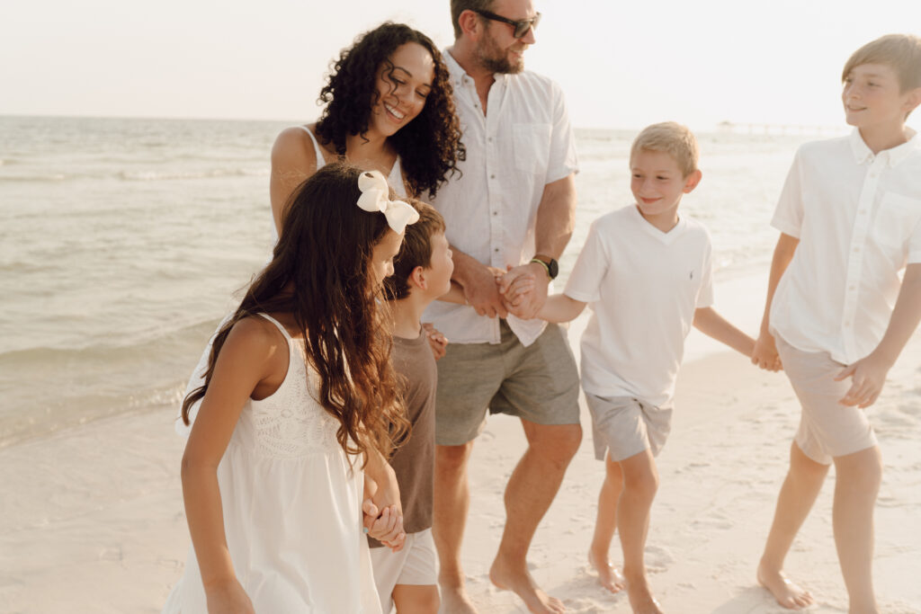 Family walking along the beach at family photo session at Destin Beach in Florida