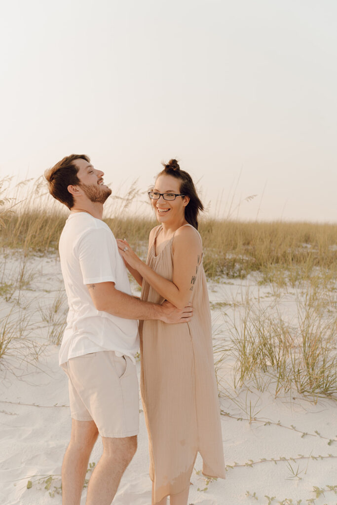 Couple hugging at beach family photo session at Destin Beach in Florida