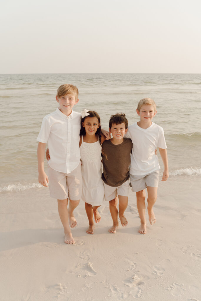 Kids playing alongside the sea at Destin Beach in Florida