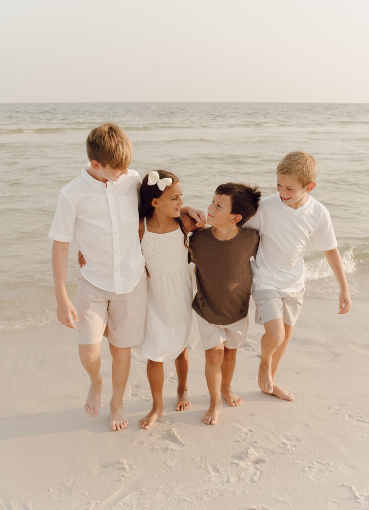 Children walking in the sea at family photo session at Destin Beach in Florida