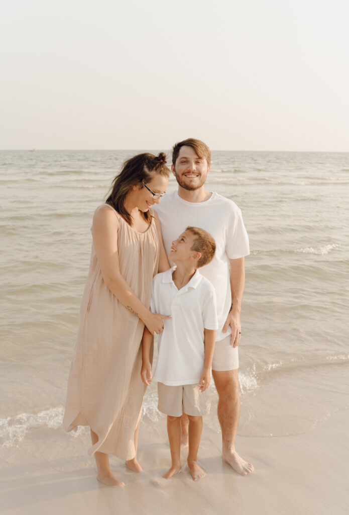 Family hugging by the sea at family photo session at Destin Beach in Florida