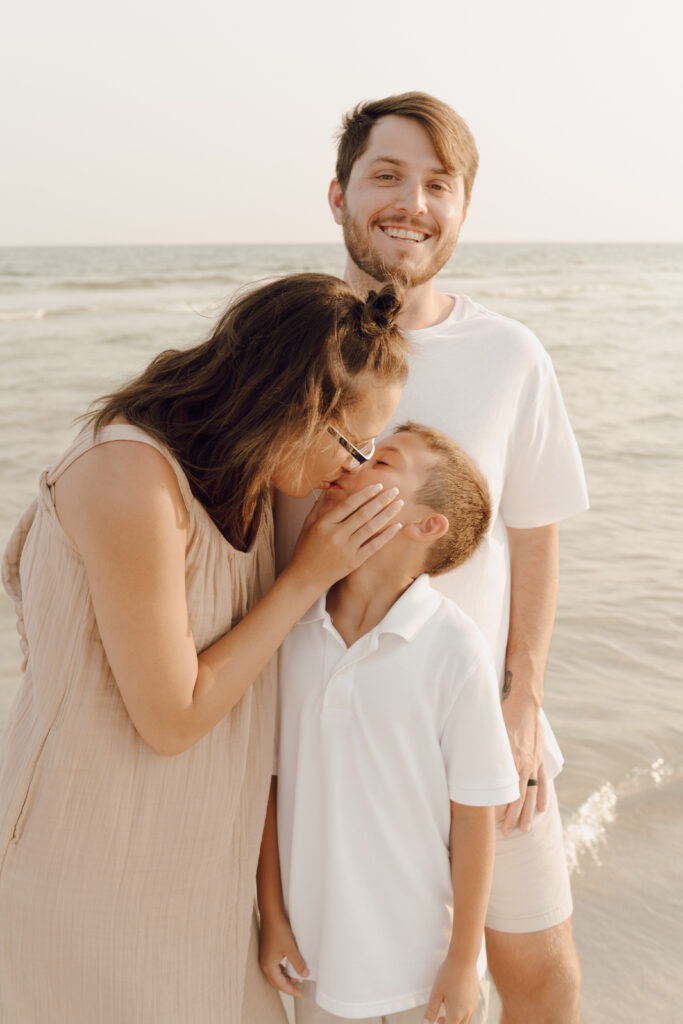 Family hugging by the beach front at Destin Beach in Florida