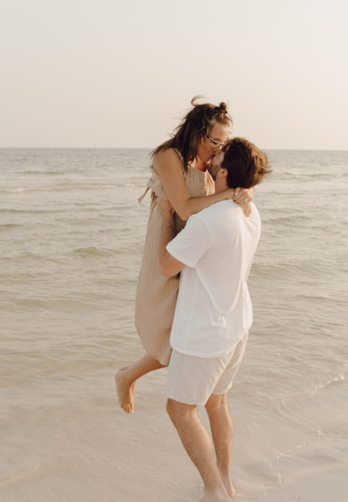 Couple kissing by the sea at family photo session at Destin Beach in Florida