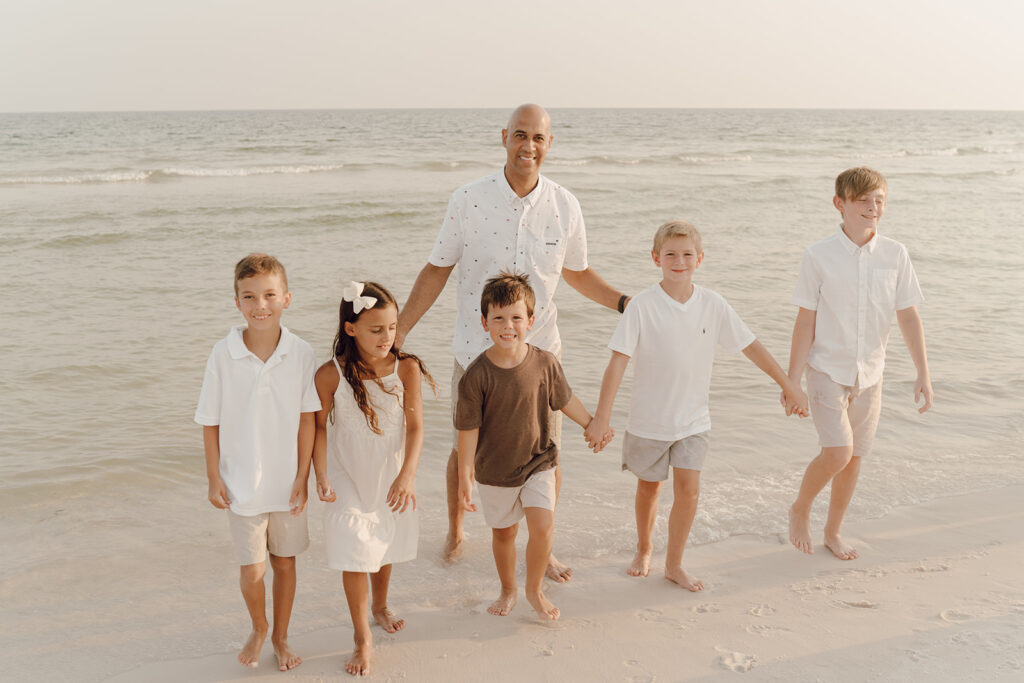 Family walking along the beach at family photo session