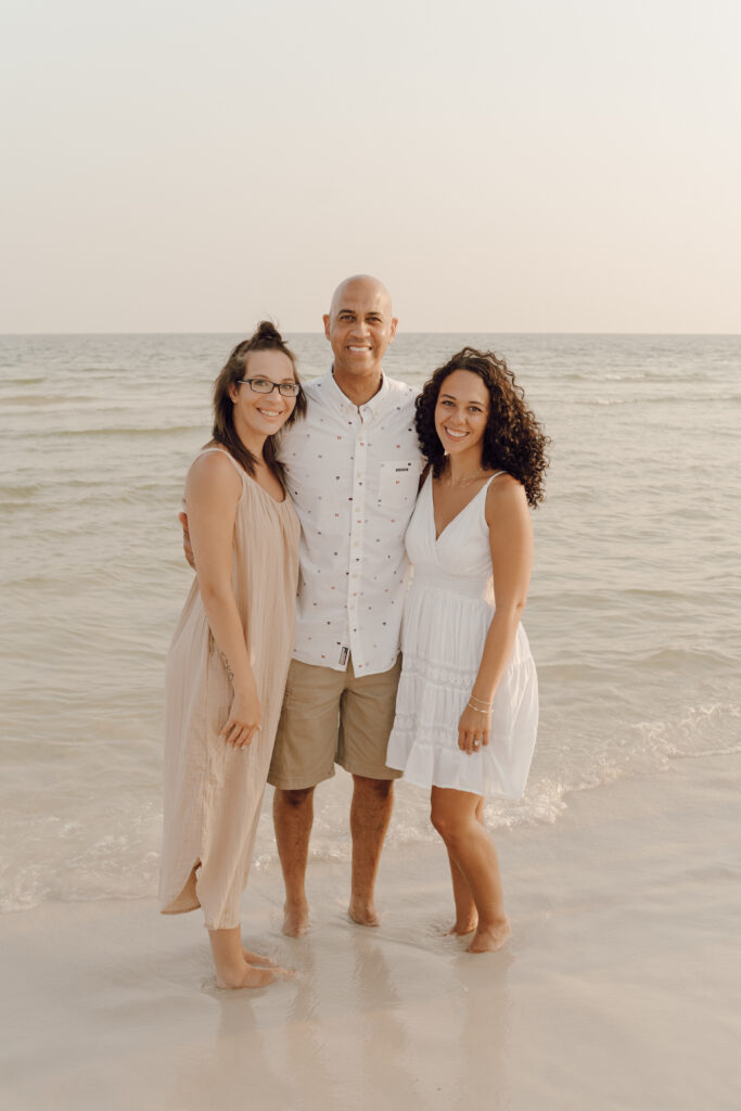 Family in sea at beach photoshoot