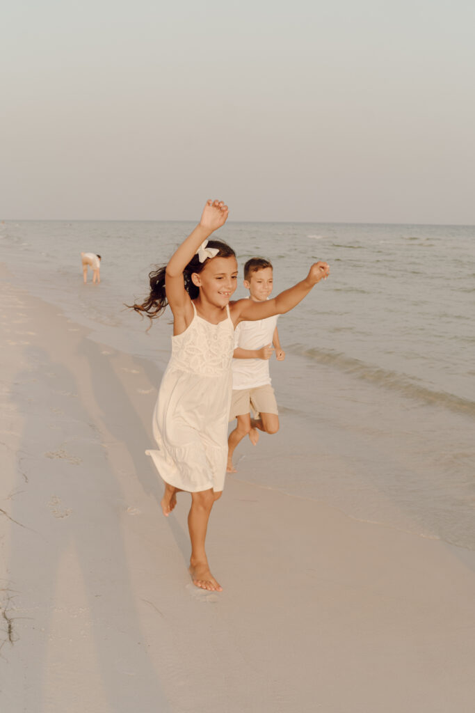 Kids running by the sea at family beach photo session