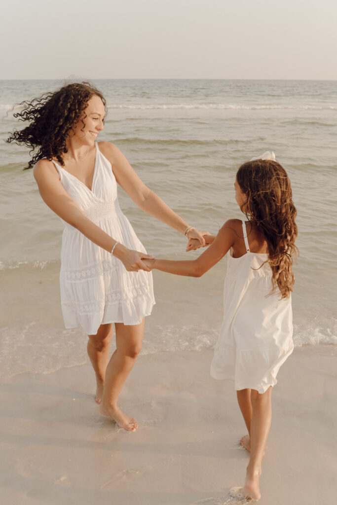 Mother and daughter playing in the sea at Destin Beach in Florida