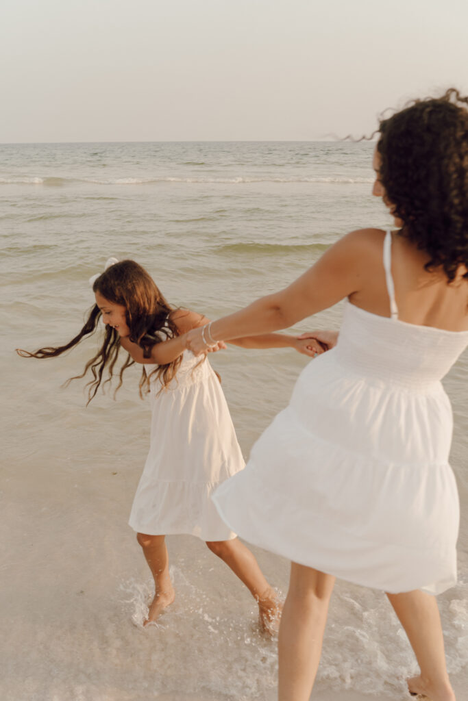 Mother and daughter playing in the sea