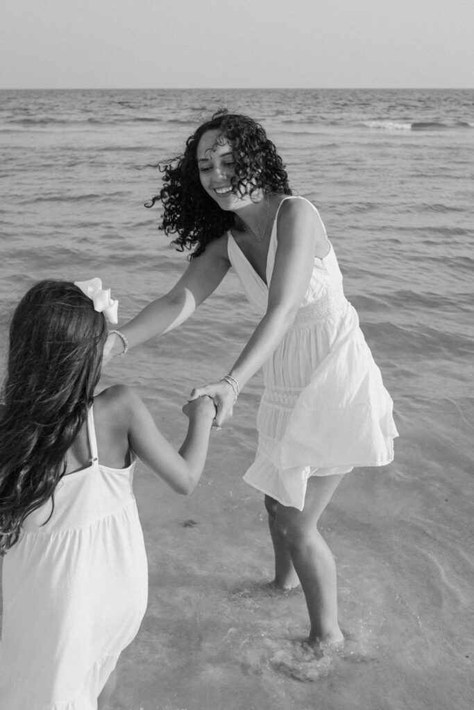 Mother and daughter playing by the sea at Destin Beach in Florida