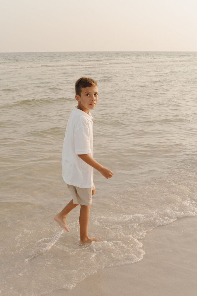 Boy playing by the ocean at Destin Beach in Florida