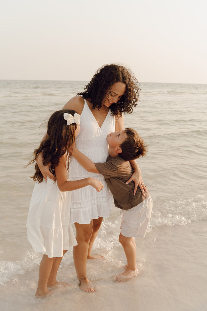 Mother and children playing by the sea at Destin Beach in Florida