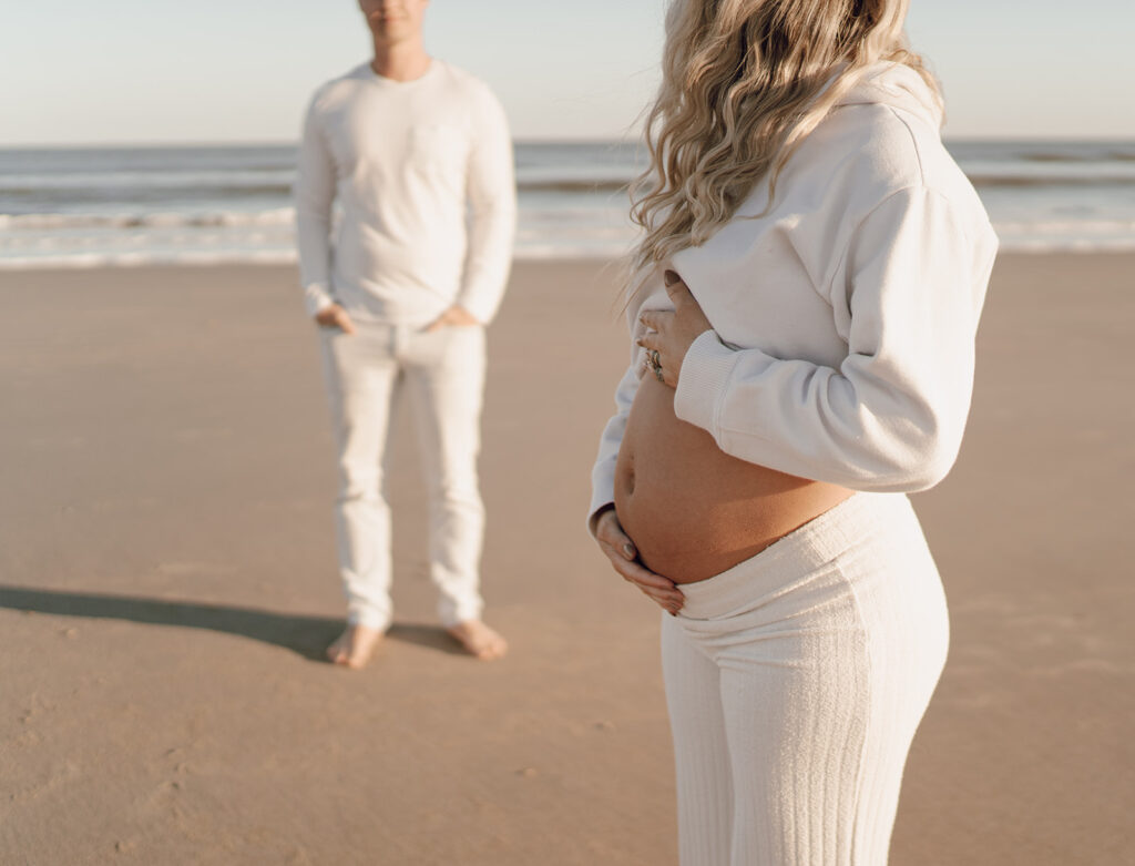 Mom to be holding baby bump during maternity shoot