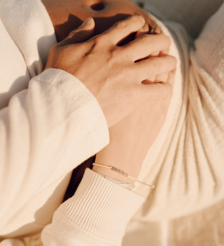 Couple hodling hands at maternity shoot 