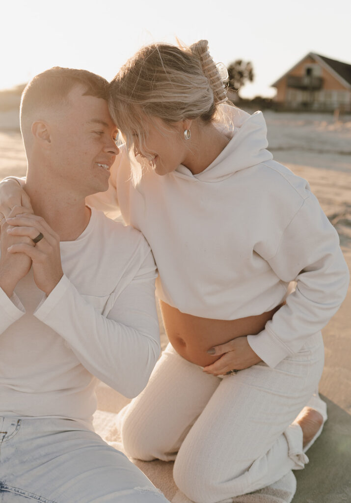 Couple hodling hands at maternity shoot