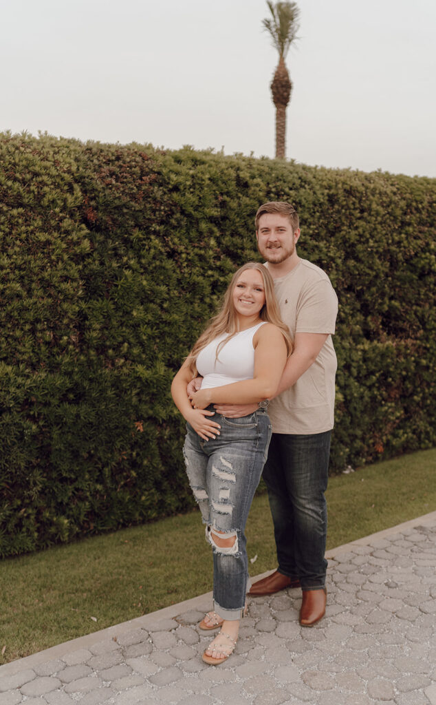 couple hugging and posing for engagement photos