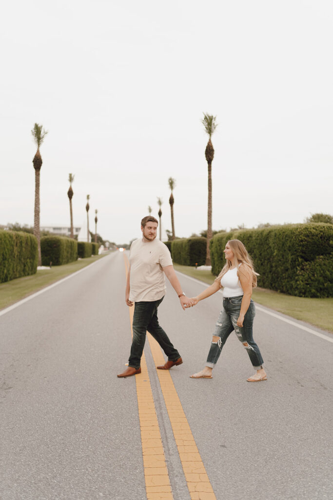 couple holding hands and taking photos in the streets of Alys FL