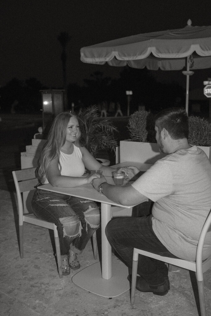 couple sharing drinks in Florida for engagement photos