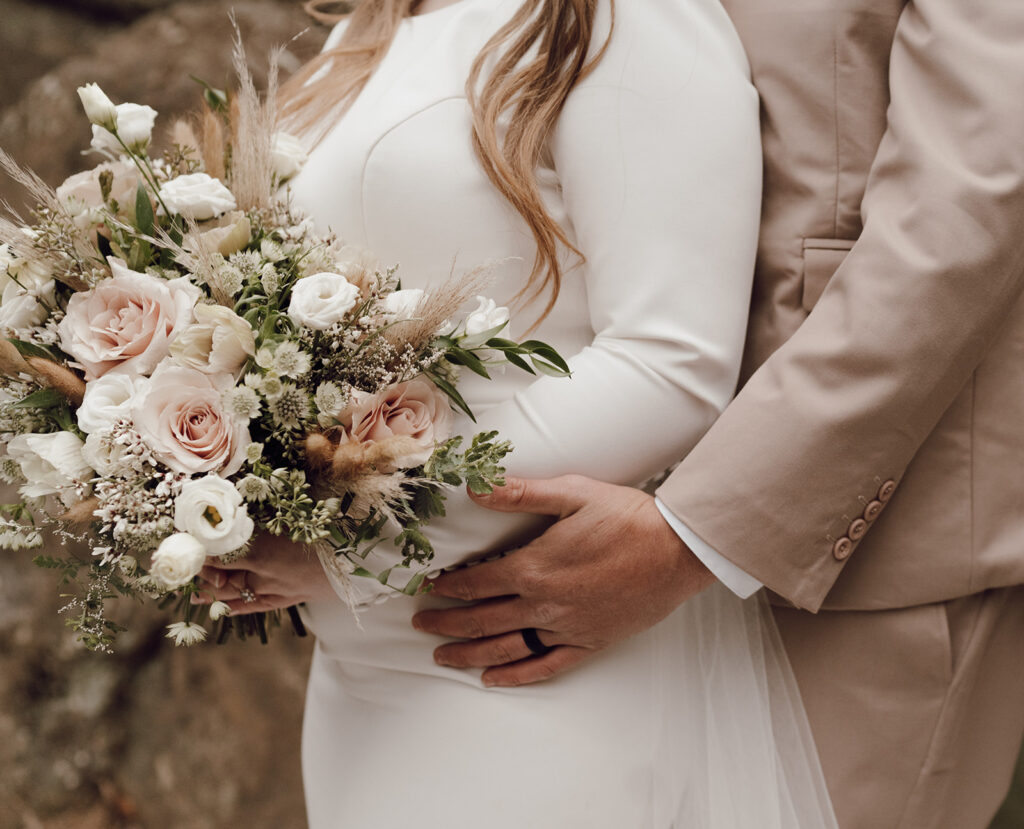 bride and groom holding wedding bouquet during elopement
