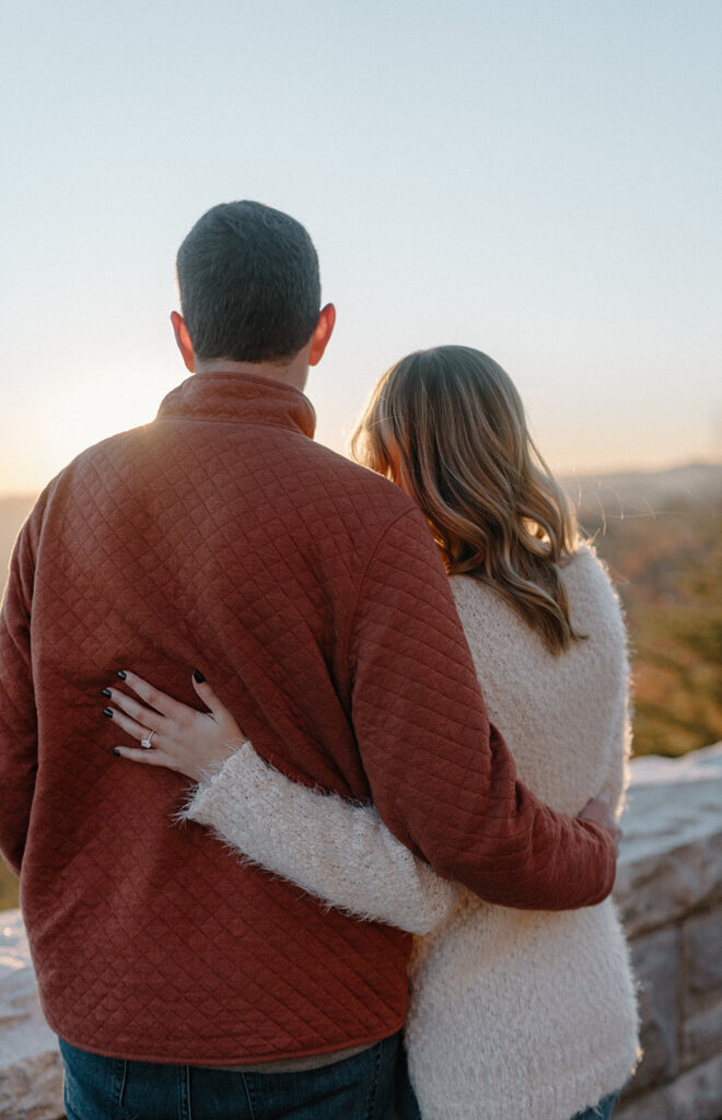 couple hugging looking at the mountains