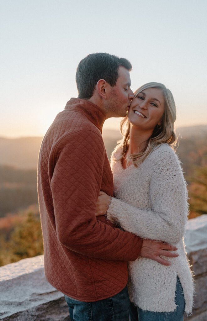 couple kissing in front of the great smoky mountains