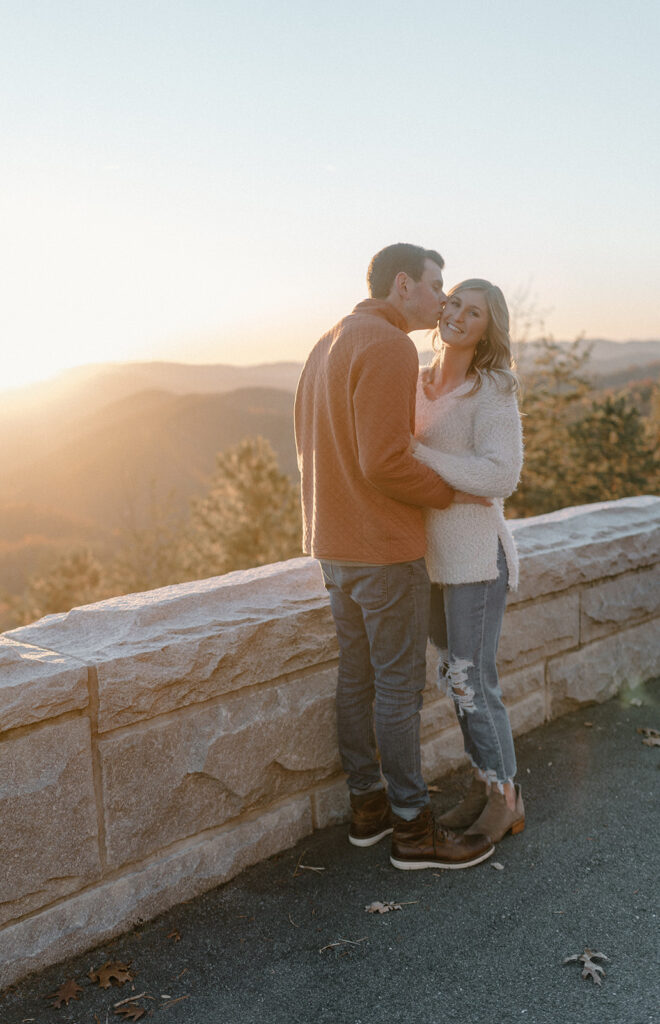 could hugging guy kissing girls cheek for smoky mountain engagement photos