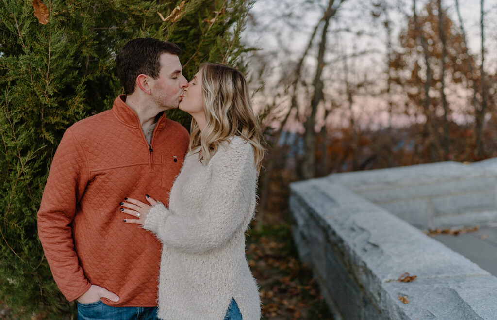 couple kissing for engagement pictures