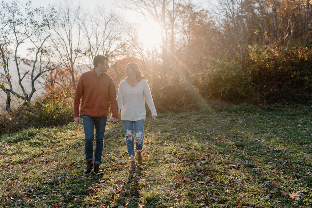 couple holding hands and walking for smoky mountain engagement photos