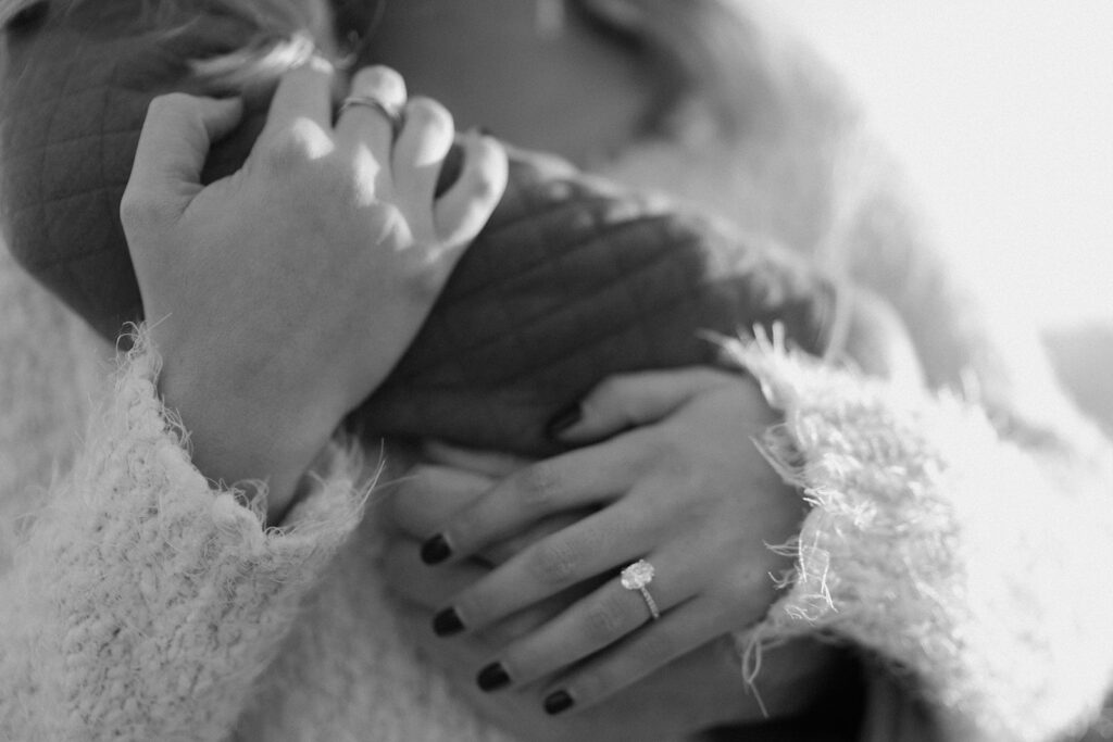 couple holding hands engagement ring photos