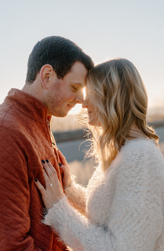 couple touching foreheads for smoky mountain engagement photos
