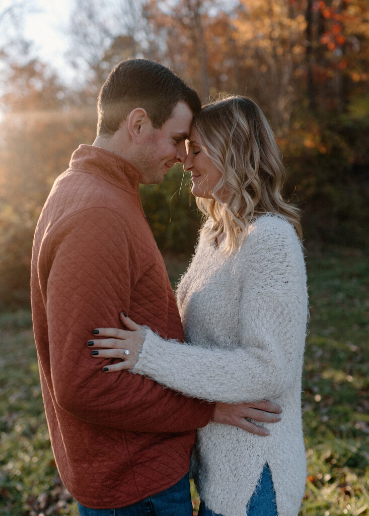couple holding onto each other during fall