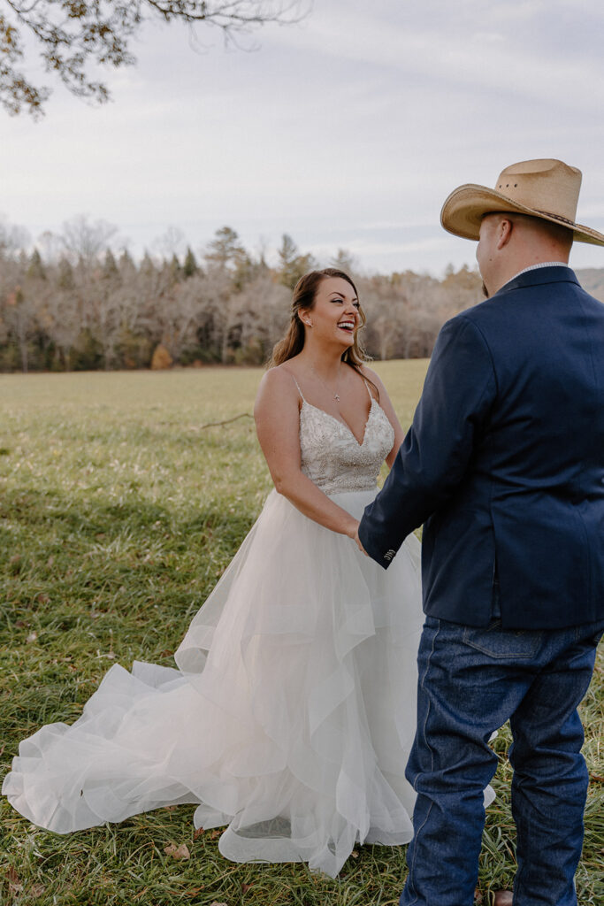 bride and groom holding hands in cades cove