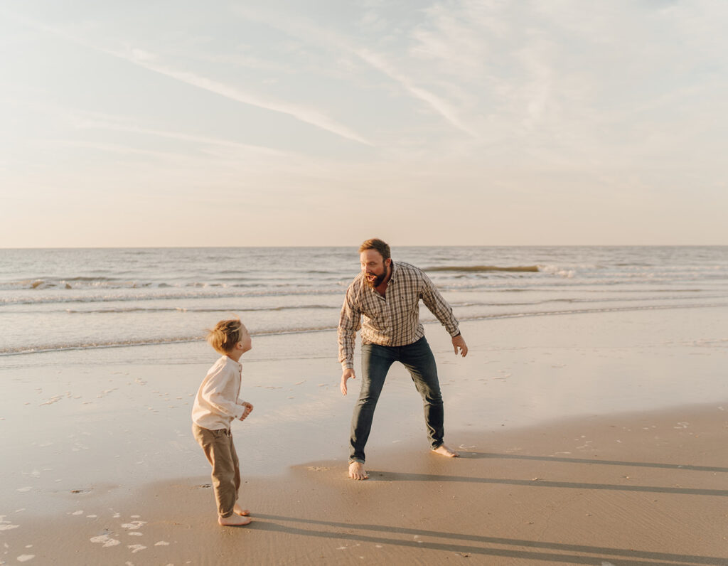 dad and son playing on the beach for beach family pictures
