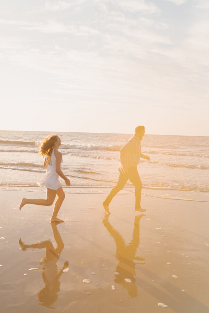 dad and daughter running for beach family pictures