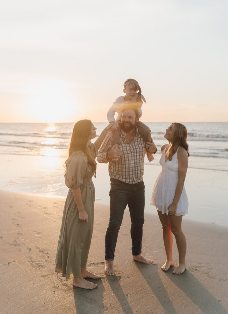 family smiling on the beach in south carolina
