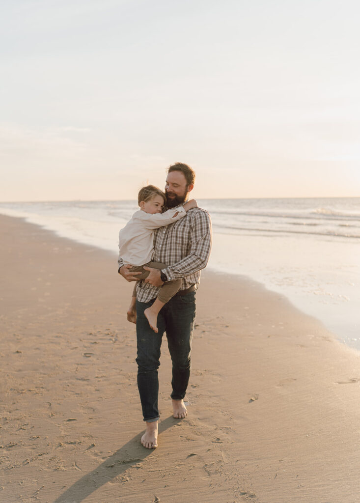 dad holding son for beach family pictures