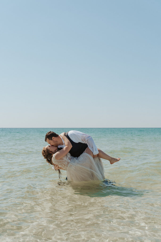 dip pose in the ocean for wedding photoshoot