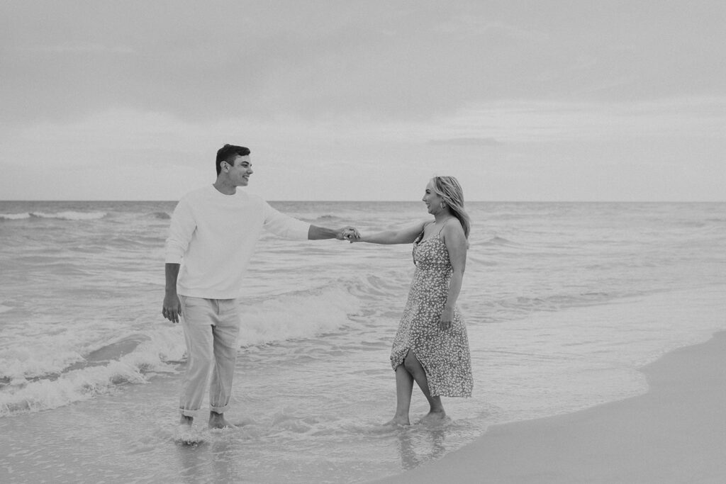 black and white engagement photos on the beach