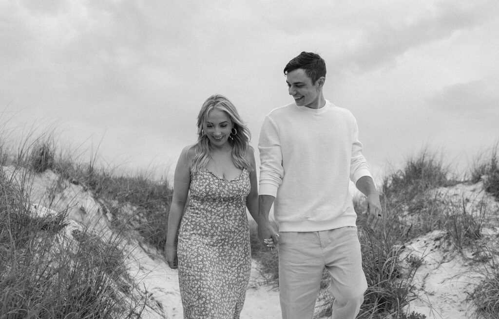 couple smiling on folly beach for seaside fl engagement photos